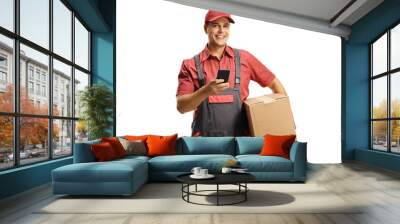 Male courier in a uniform holding a box and using a mobile phone Wall mural