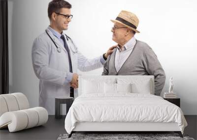 Male doctor and a mature man shaking hands Wall mural