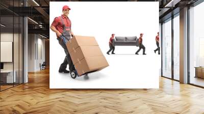 Male worker pushing a hand-truck and other workers carrying furniture Wall mural