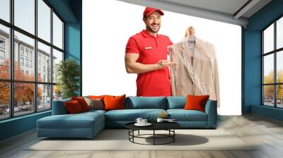 Male worker showing a suit from dry cleaners Wall mural