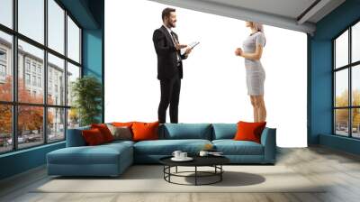 Man in a formal black suit and a woman in a casual dress having a conversation Wall mural