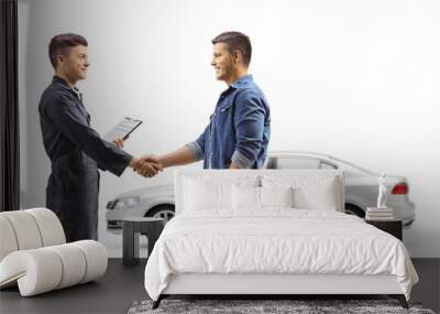 Man taking car to an auto repair shop and shaking hands with auto mechanic worker Wall mural