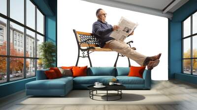 Mature man sitting on bench and reading a newspaper Wall mural