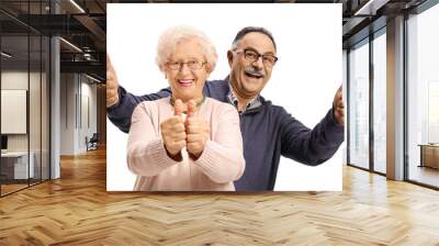 Mature man woth his elderly mother smiling and showing thumbs up Wall mural