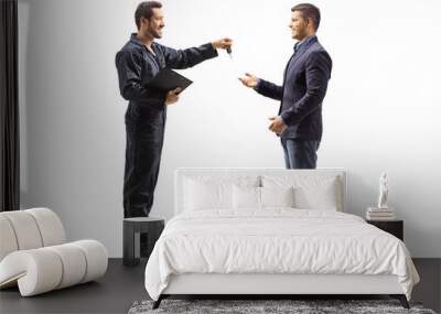 Mechanic holding a clipboard and giving keys to a male customer Wall mural