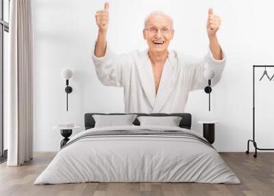 Overjoyed senior giving two thumbs up Wall mural