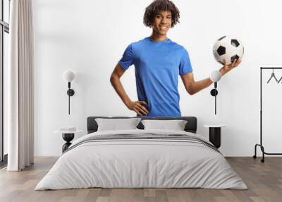 Portrait of an african american football player smiling and holding a ball Wall mural