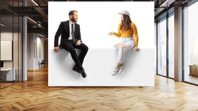 Prfessional man in suit and tie sitting on a panel and listening to a young female in casual clothes Wall mural