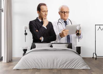 Professional man and a mature male doctor looking at a digital tablet Wall mural