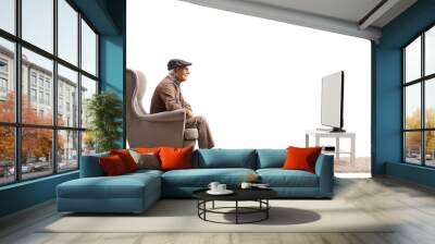 Profile shot of a pensioner sitting in an armchair and watching tv Wall mural