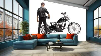 Rear view of a biker in a leather jacket with a chopper holding a helmet Wall mural