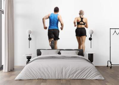 Rear view shot of a man and woman jogging Wall mural