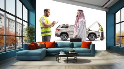 Road assistance agent talking to a saudi arab man and fixing his car Wall mural