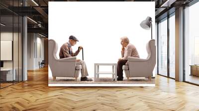 Sad elderly man and woman sitting in armchairs Wall mural