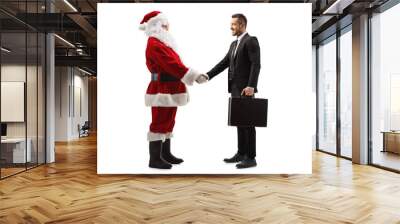 Santa claus shaking hands with a businessman Wall mural