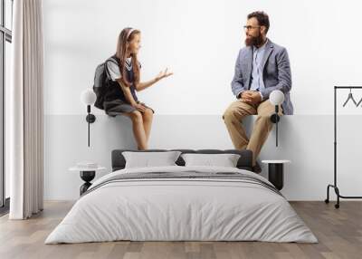 Schoolgirl and a bearded man sitting on a blank panel and talking Wall mural