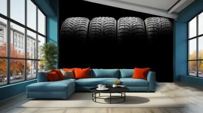 Set of four black car tires lined up horizontally Wall mural