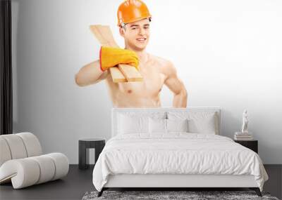 Shirtless muscular male construction worker holding sills Wall mural