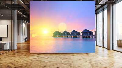 Sunset on Maldives island, water villas resort Wall mural