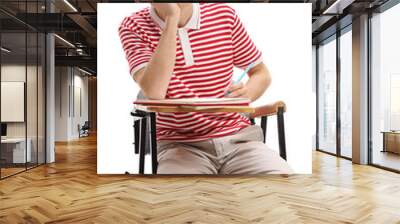 Teen student sitting in a school chair and taking notes Wall mural