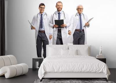 Three male doctors smiling and walking towards camera Wall mural