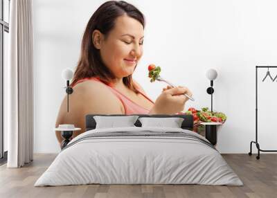 Woman eating a salad and trying to lose weight Wall mural