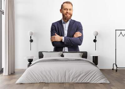 Young bearded man in a suit and jeans posing with crossed arms Wall mural