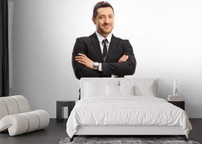 Young busniessman wearing a black suit and posing with arms crossed Wall mural