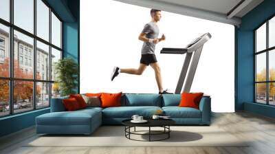 Young guy running on a professional treadmill Wall mural