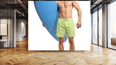 Young handsome man holding a surfing board and smiling Wall mural