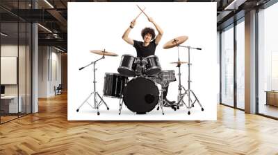 Young male drummer holding drumsticks up Wall mural