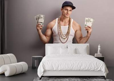 Young male rapper holding money Wall mural