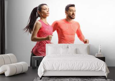 Young man and woman in sportswear running together Wall mural