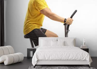 Young man cycling on a stationary bike Wall mural