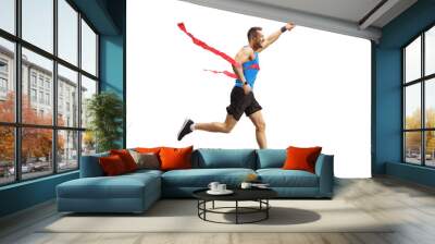 Young man finishing a relay race and holding a baton Wall mural