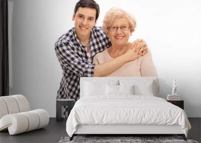 Young man hugging a senior lady Wall mural