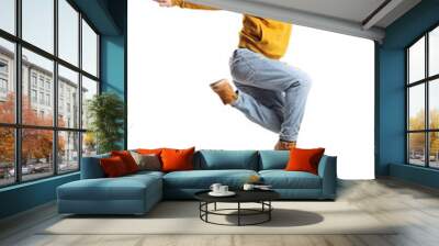 Young man in a yellow sweatshirt jumping and smiling Wall mural