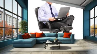 Young smiling businessman sitting in office chair and working on Wall mural