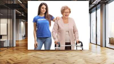 Young volunteer helping a senior lady with a walker Wall mural