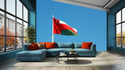 in oman waving flag and the cloudy sky Wall mural