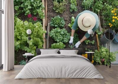 A person gardening in their lush backyard, planting flowers and vegetables in neatly arranged beds. They're wearing gardening gloves and a sunhat, with a watering can and tools nearby. Wall mural