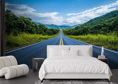 An open road stretching into the distance, framed by lush greenery and under a clear, bright sky, the road appearing endless and inviting, representing limitless possibilities and freedom of choice Wall mural