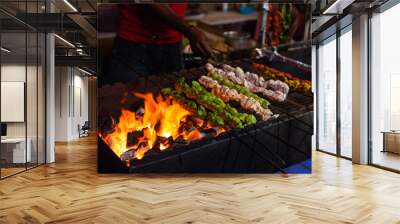 Street food/Traditional Grilled tandoori of  assorted meats with charcoal and fire on skewers Wall mural