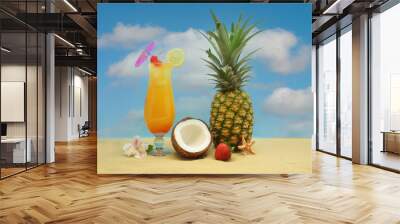 pineapple, tropical drink and fruit on sand with sky Wall mural