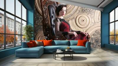 Queen in red dress sitting on throne. Symbol of power Wall mural