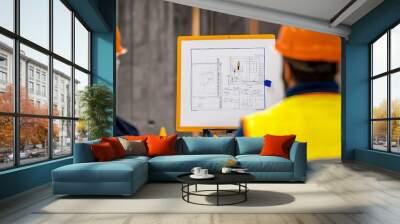 Construction engineer presenting site safety plan Wall mural