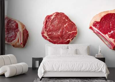 Three cuts of fresh beef steak arranged on a white background ready for cooking or grilling. Wall mural