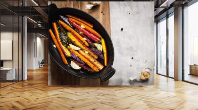 Colorful carrots and potatoes in a black pan Wall mural