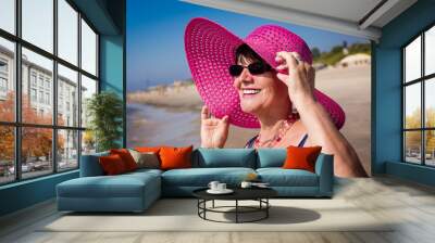 Happy mature woman on the beach. Selective focus. Wall mural