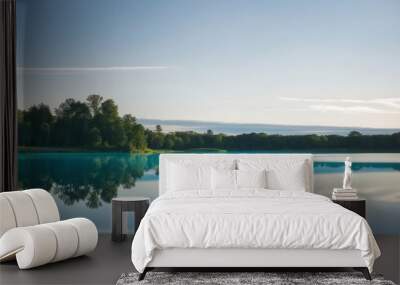 A serene lake scene with a clear blue surface and a white sky in the background. Wall mural